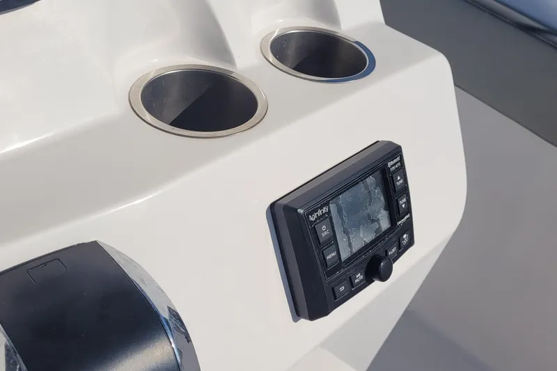 Slide: The Image of 2022 Aquasport 2100 Center Console dashboard with cup holders and control panel. - 31