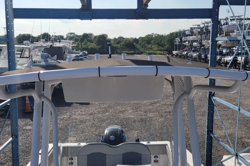 Slide: The Image of 2022 Aquasport 2100 Center Console boat in storage yard, surrounded by other vessels. - 32