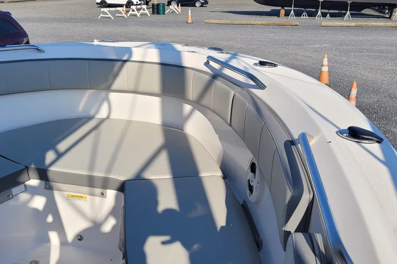 Slide: The Image of 2022 Aquasport 2100 Center Console boat interior with cushioned seating and stainless steel rails. - 34