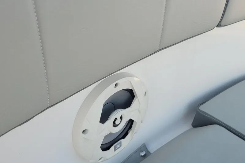 Slide: The Image of 2022 Aquasport 2100 Center Console boat interior with speaker and cushioned seating. - 43