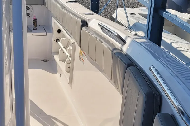 Slide: The Image of 2022 Aquasport 2100 Center Console boat interior with seating and storage compartments. - 44