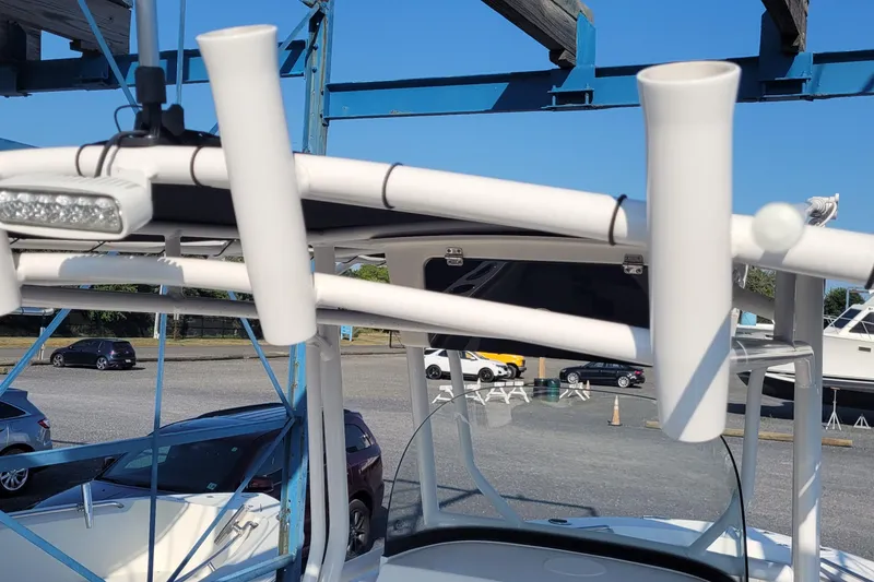 Slide: The Image of 2022 Aquasport 2100 Center Console boat with rod holders and LED light. - 48