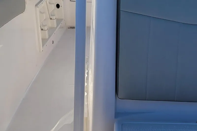 Slide: The Image of 2022 Aquasport 2100 Center Console interior detail, featuring seating and storage area. - 51