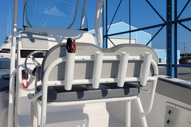 Slide: The Image of 2022 Aquasport 2100 Center Console boat interior with rod holders and Garmin equipment. - 52