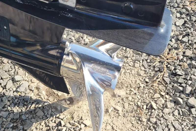 Slide: The Image of Close-up of a Suzuki propeller on a 2022 Aquasport 2100 Center Console boat. - 57