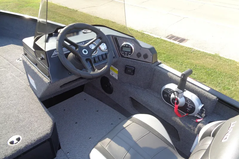 Slide: The Image of 2026 Lund 1775 Adventure SS boat interior with steering wheel and control panel. - 14