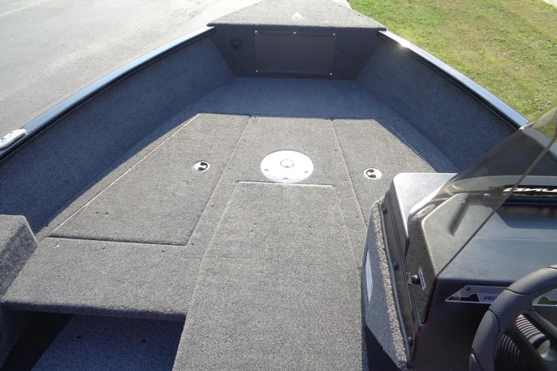 Slide: The Image of 2026 Lund 1775 Adventure SS boat interior with carpeted deck and console. - 15