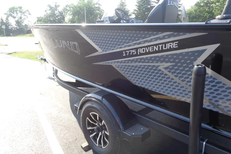 Slide: The Image of 2026 Lund 1775 Adventure SS boat on trailer, featuring sleek black design. - 3