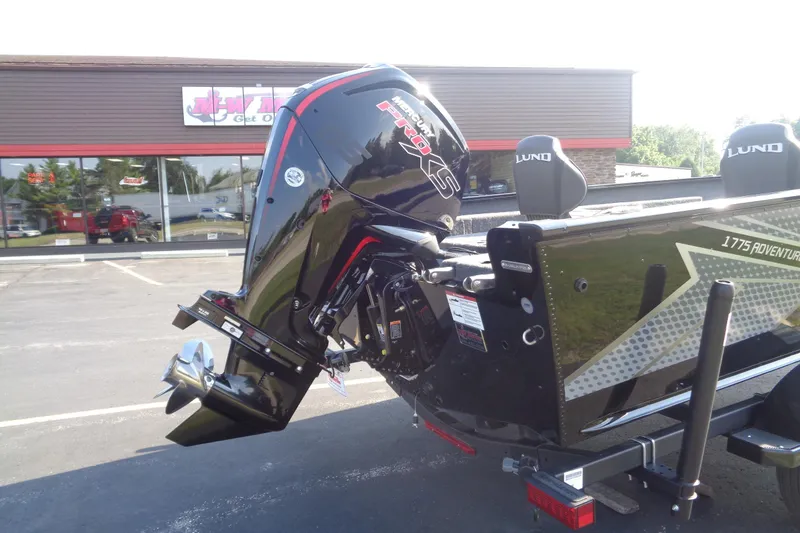 Slide: The Image of 2026 Lund 1775 Adventure SS boat with powerful outboard motor in parking lot. - 5
