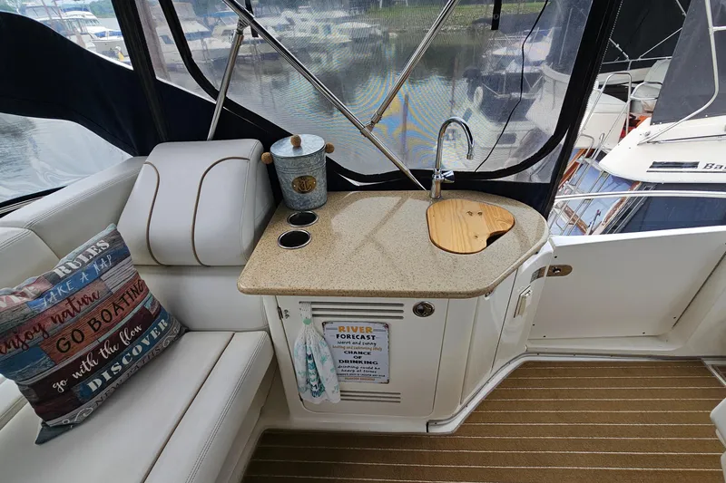 Slide: The Image of 2007 Silverton 38 Sport Bridge interior with kitchenette, sink, and decorative pillows. - 10