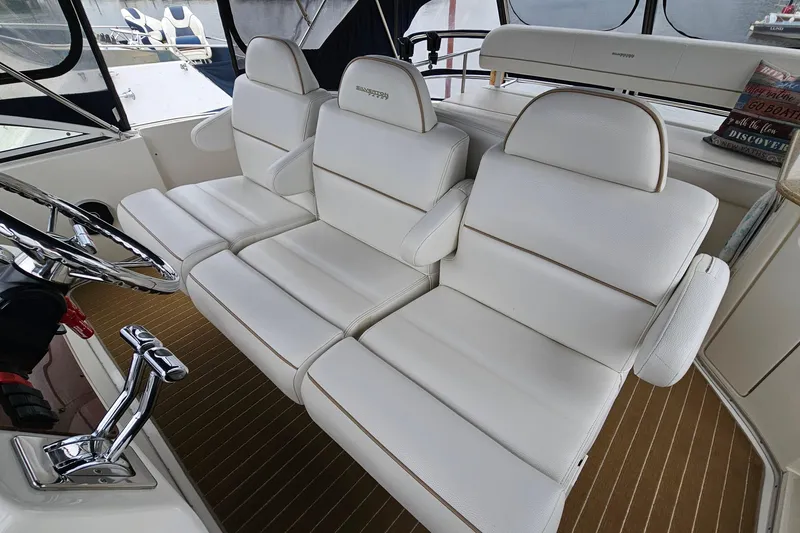 Slide: The Image of 2007 Silverton 38 Sport Bridge interior with white leather seating and steering wheel. - 12