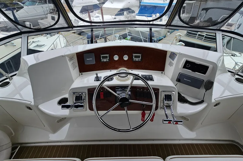 Slide: The Image of 2007 Silverton 38 Sport Bridge helm with steering wheel and control panel. - 13