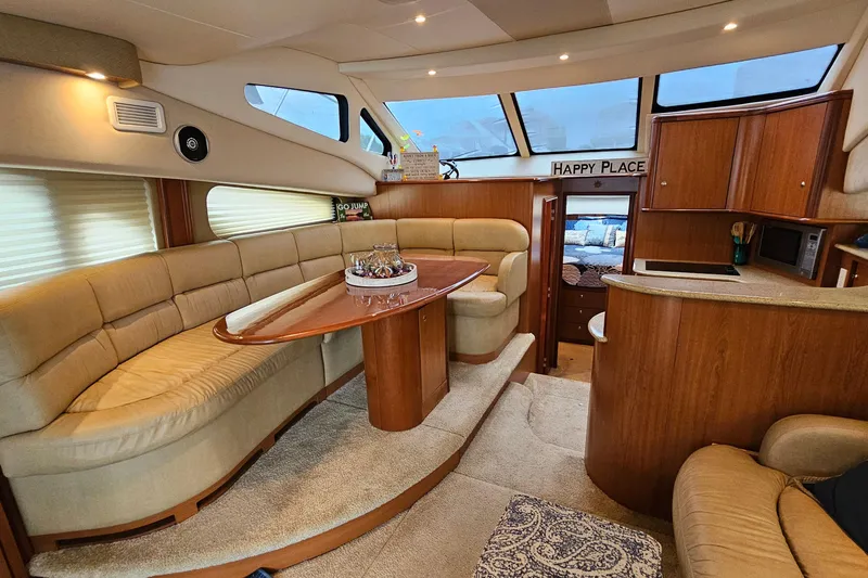 Slide: The Image of Luxurious interior of 2007 Silverton 38 Sport Bridge yacht with elegant seating and dining area. - 18