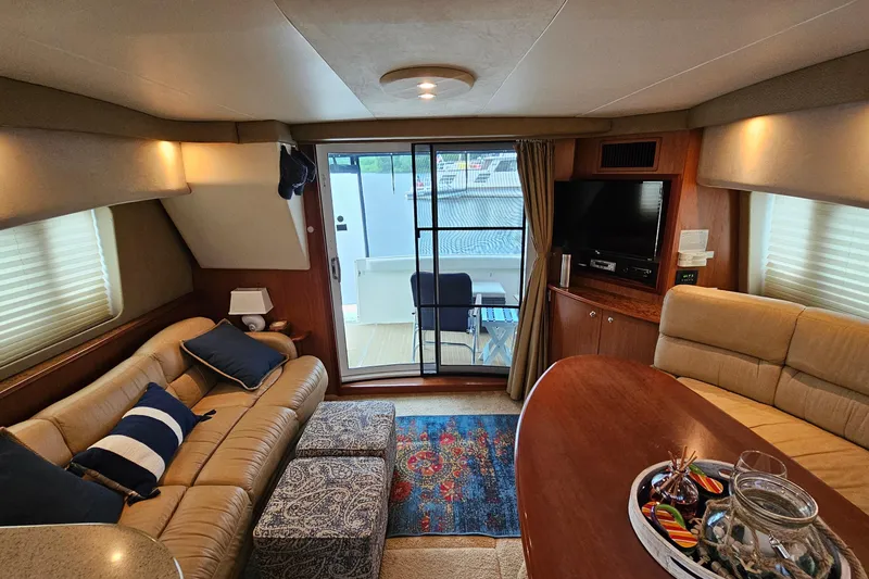 Slide: The Image of Luxurious interior of a 2007 Silverton 38 Sport Bridge yacht with cozy seating and decor. - 19