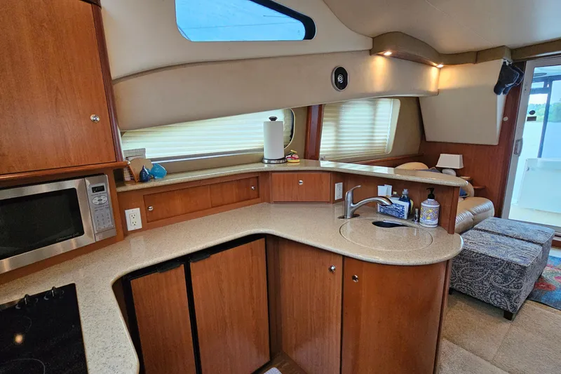 Slide: The Image of Interior of 2007 Silverton 38 Sport Bridge yacht with modern kitchen and seating area. - 23