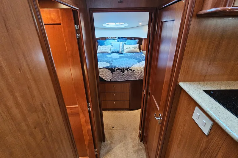 Slide: The Image of 2007 Silverton 38 Sport Bridge interior with cozy bedroom and wooden cabinetry. - 24