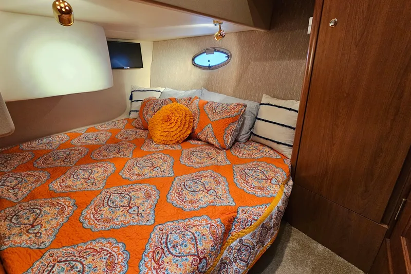 Slide: The Image of Cozy bedroom in 2007 Silverton 38 Sport Bridge with vibrant orange bedding. - 28