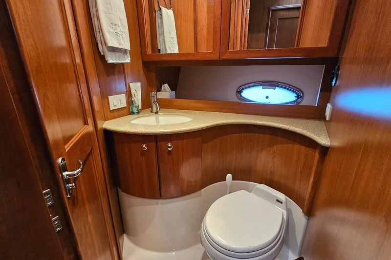 Slide: The Image of Luxurious 2007 Silverton 38 Sport Bridge yacht bathroom with wood cabinetry and modern fixtures. - 29
