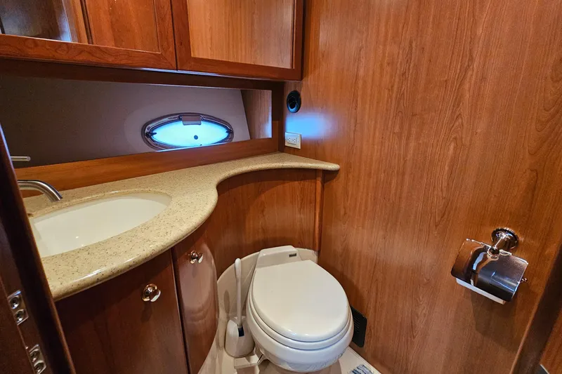 Slide: The Image of Luxurious 2007 Silverton 38 Sport Bridge yacht bathroom with wood finish and modern amenities. - 30