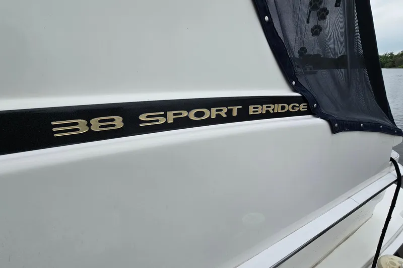 Slide: The Image of 2007 Silverton 38 Sport Bridge boat side view with logo and cover. - 34