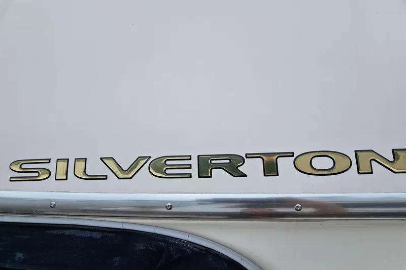 Slide: The Image of Silverton 38 Sport Bridge 2007 boat logo on white surface. - 35