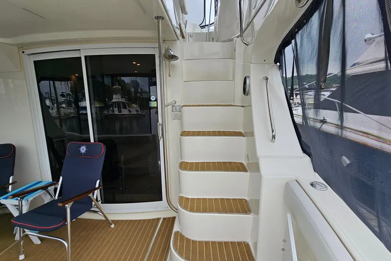 Slide: The Image of 2007 Silverton 38 Sport Bridge yacht interior with stairs and seating area. - 6