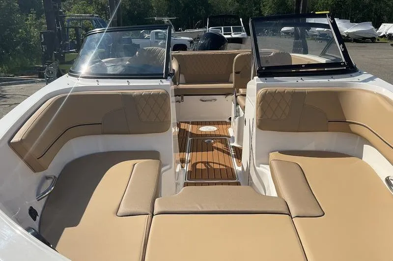 Slide: The Image of 2025 Bayliner VR5 OB boat interior with tan seating and open deck layout. - 10