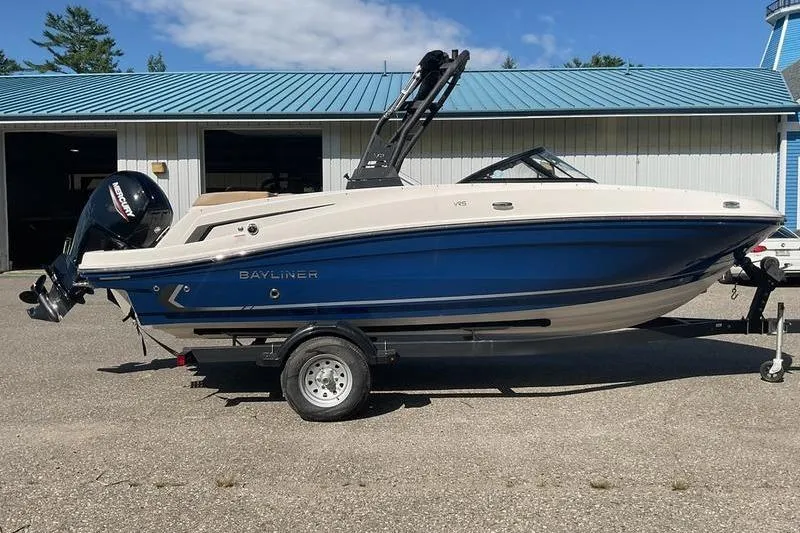 Slide: The Image of 2025 Bayliner VR5 OB boat on trailer, parked outside a building. - 5