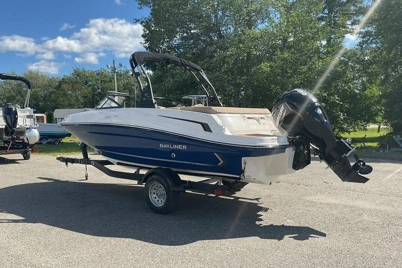 Slide: The Image of 2025 Bayliner VR5 OB boat on trailer, parked outdoors under clear sky. - 7