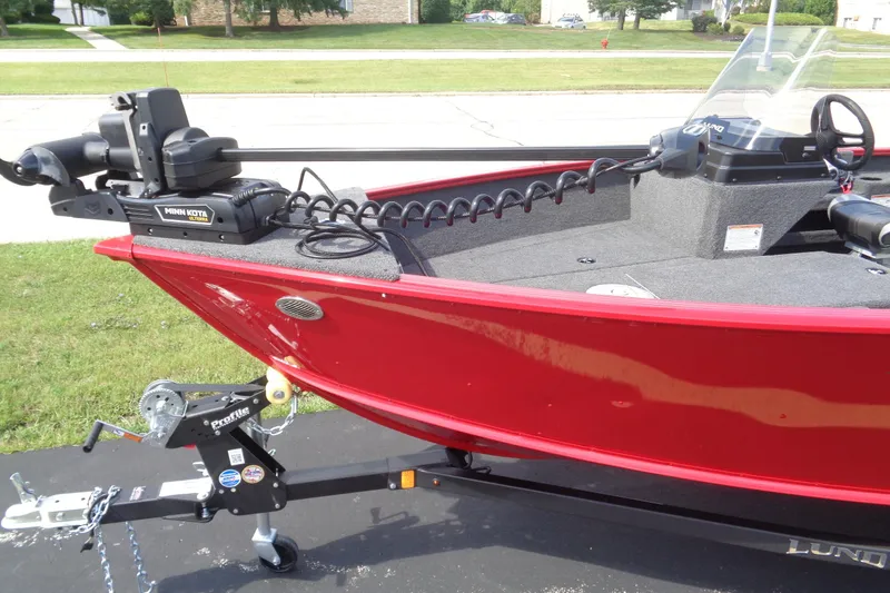Slide: The Image of 2026 Lund 1775 Adventure SS boat with Minn Kota motor, red exterior, on trailer. - 3