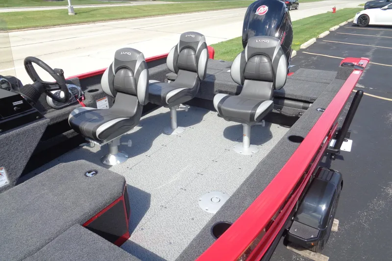 Slide: The Image of 2026 Lund 1775 Adventure SS boat interior with three seats and steering wheel. - 4