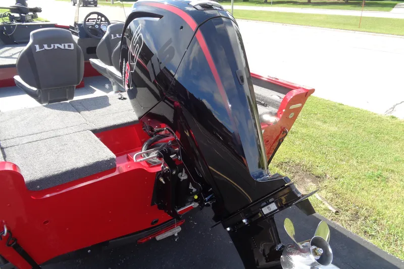 Slide: The Image of 2026 Lund 1775 Adventure SS boat with powerful outboard motor, red and black design. - 7