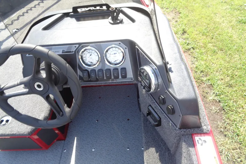 Slide: The Image of 2026 Lund 1775 Adventure SS boat dashboard with steering wheel and gauges. - 8