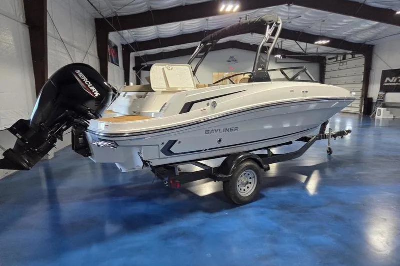 Slide: The Image of 2025 Bayliner VR5 OB boat on trailer in indoor showroom. - 10