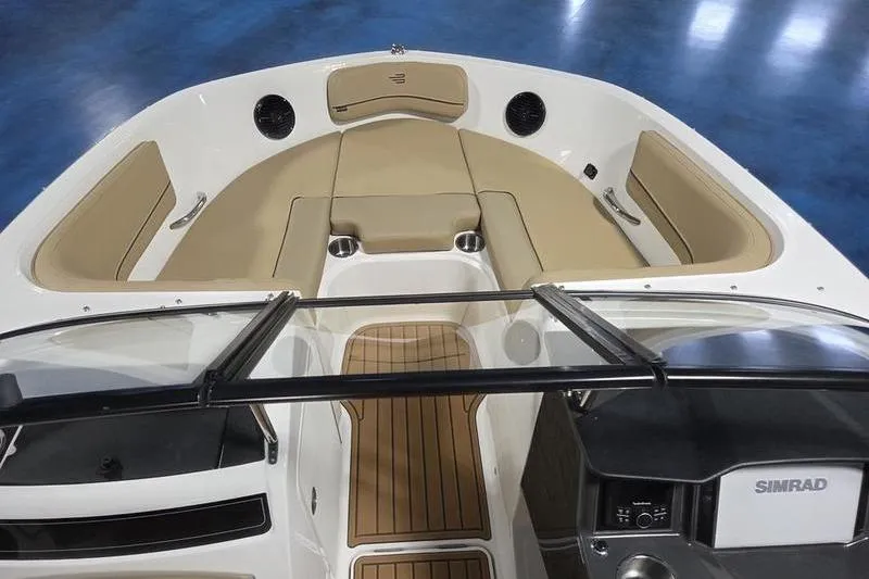 Slide: The Image of 2025 Bayliner VR5 OB boat interior with tan seating and Simrad navigation system. - 14