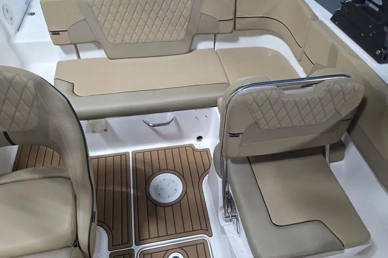 Slide: The Image of 2025 Bayliner VR5 OB boat interior with beige seating and wood-patterned flooring. - 15
