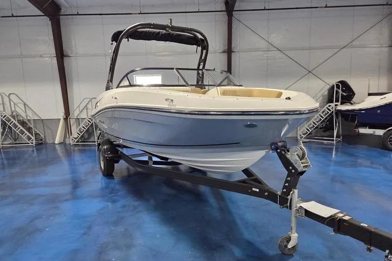 Slide: The Image of 2025 Bayliner VR5 OB boat on trailer in indoor showroom. - 3