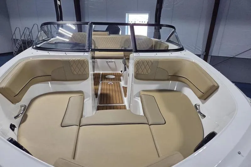Slide: The Image of 2025 Bayliner VR5 OB boat interior with tan seating and wood flooring. - 4