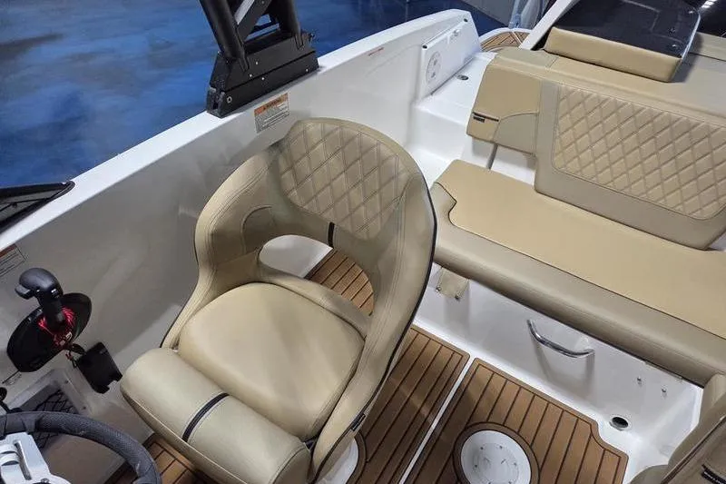 Slide: The Image of 2025 Bayliner VR5 OB boat interior with beige seating and wood-style flooring. - 9
