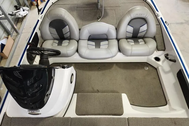Slide: The Image of Interior of a 2017 Nitro Z17 boat with gray seating and steering console. - 6