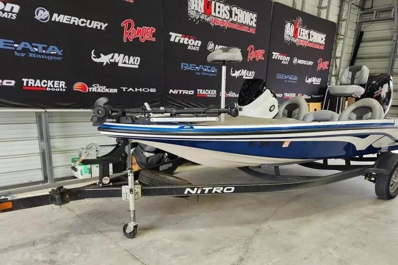Slide: The Image of 2017 Nitro Z17 boat on trailer in showroom with branded backdrop. - 9