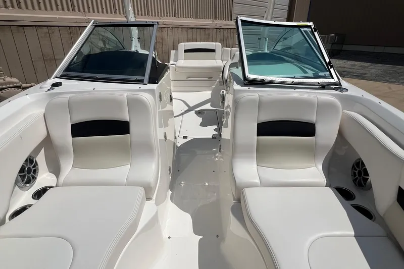 Slide: The Image of 2016 Chaparral 244 Sunesta boat interior with white seating and open windshield. - 10