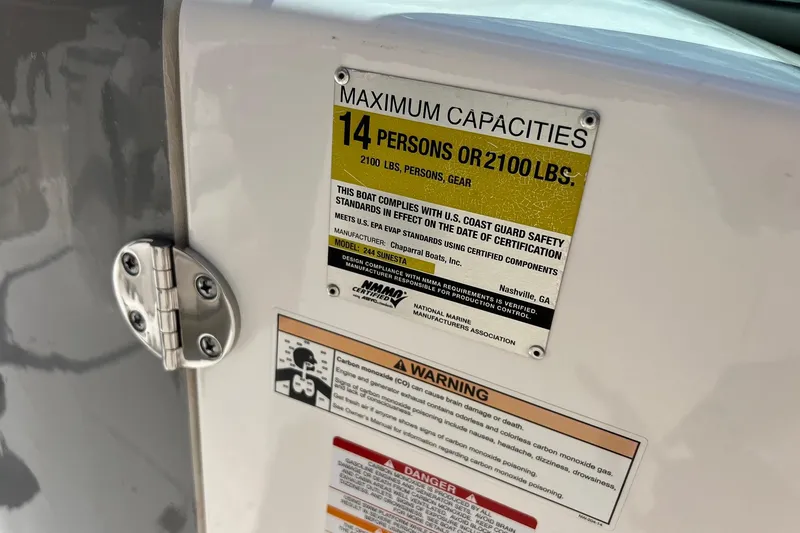 Slide: The Image of 2016 Chaparral 244 Sunesta capacity label, maximum 14 persons or 2100 lbs, safety compliance. - 11