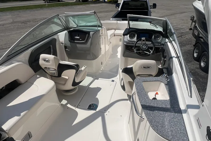 Slide: The Image of 2016 Chaparral 244 Sunesta boat interior with seating, steering wheel, and dashboard. - 12