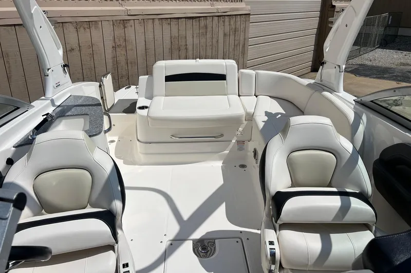 Slide: The Image of 2016 Chaparral 244 Sunesta boat interior with white seating and modern design. - 13