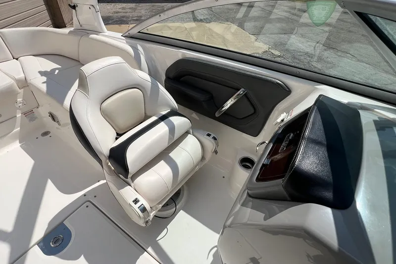 Slide: The Image of 2016 Chaparral 244 Sunesta boat interior with white seating and sleek dashboard design. - 14