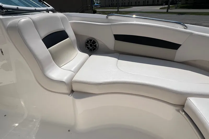 Slide: The Image of 2016 Chaparral 244 Sunesta boat interior with white cushioned seating and speaker. - 5