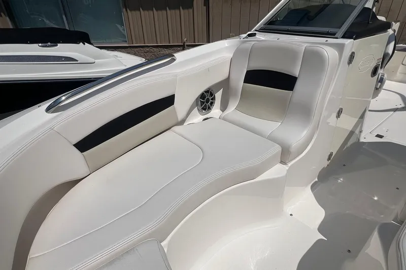 Slide: The Image of 2016 Chaparral 244 Sunesta boat interior with white seating and speaker. - 6