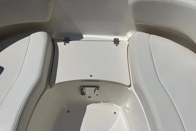 Slide: The Image of 2016 Chaparral 244 Sunesta boat interior seating with storage compartment. - 8