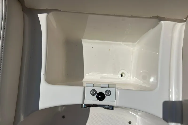 Slide: The Image of 2016 Chaparral 244 Sunesta boat storage compartment with drain plug. - 9